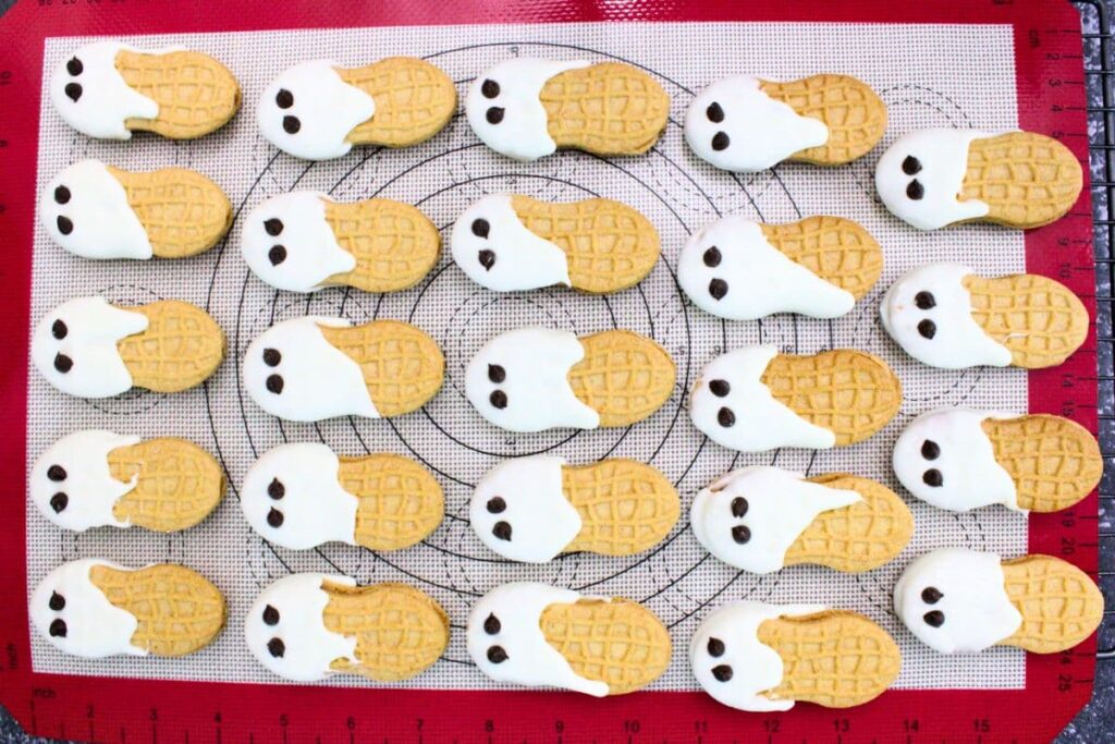 add chocolate chips for eyes to each of the ghosts