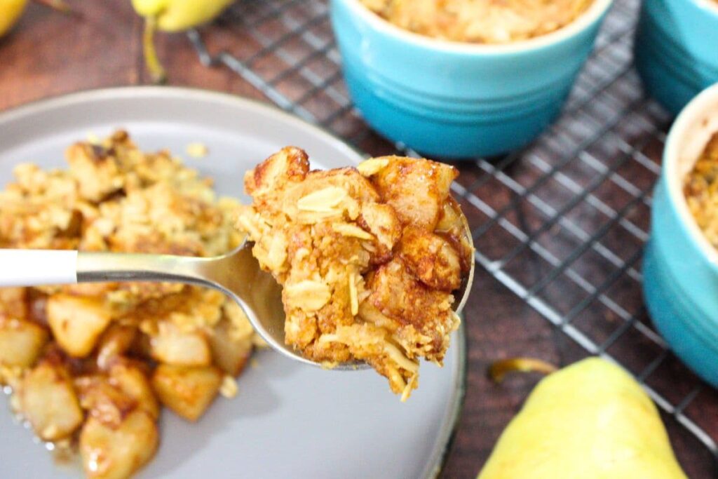 holding up a spoonful of air fryer pear crisp