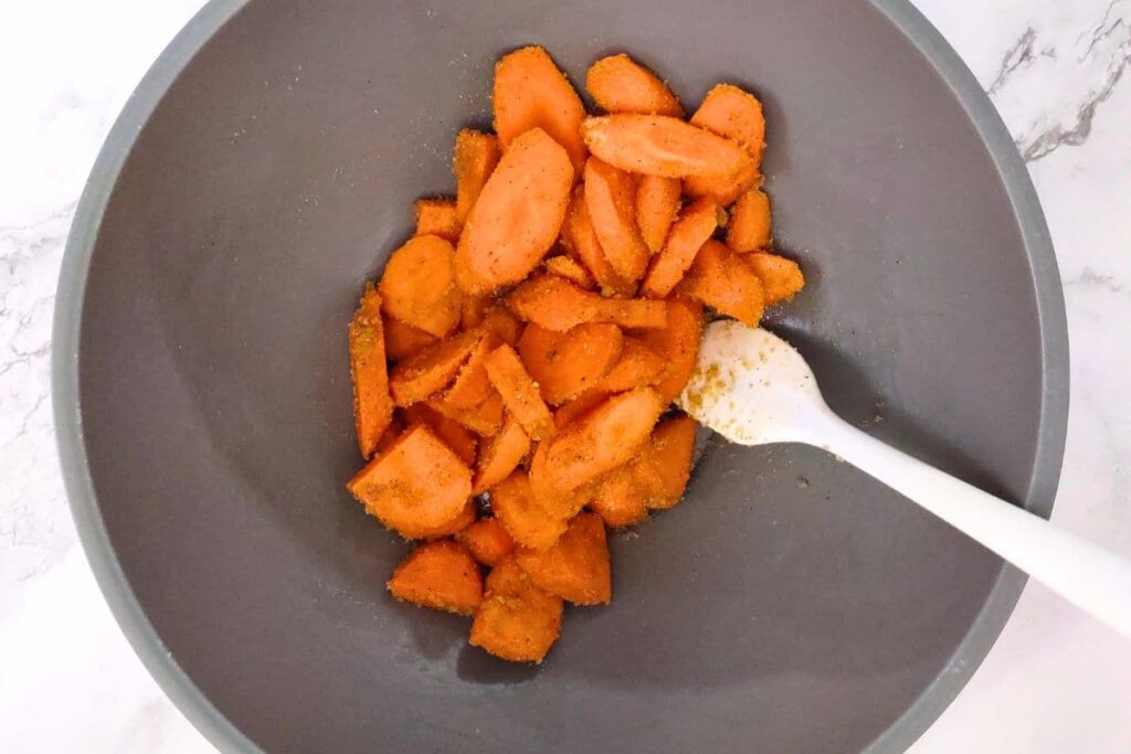 in a bowl toss your carrots with olive oil, brown sugar, salt, and pepper