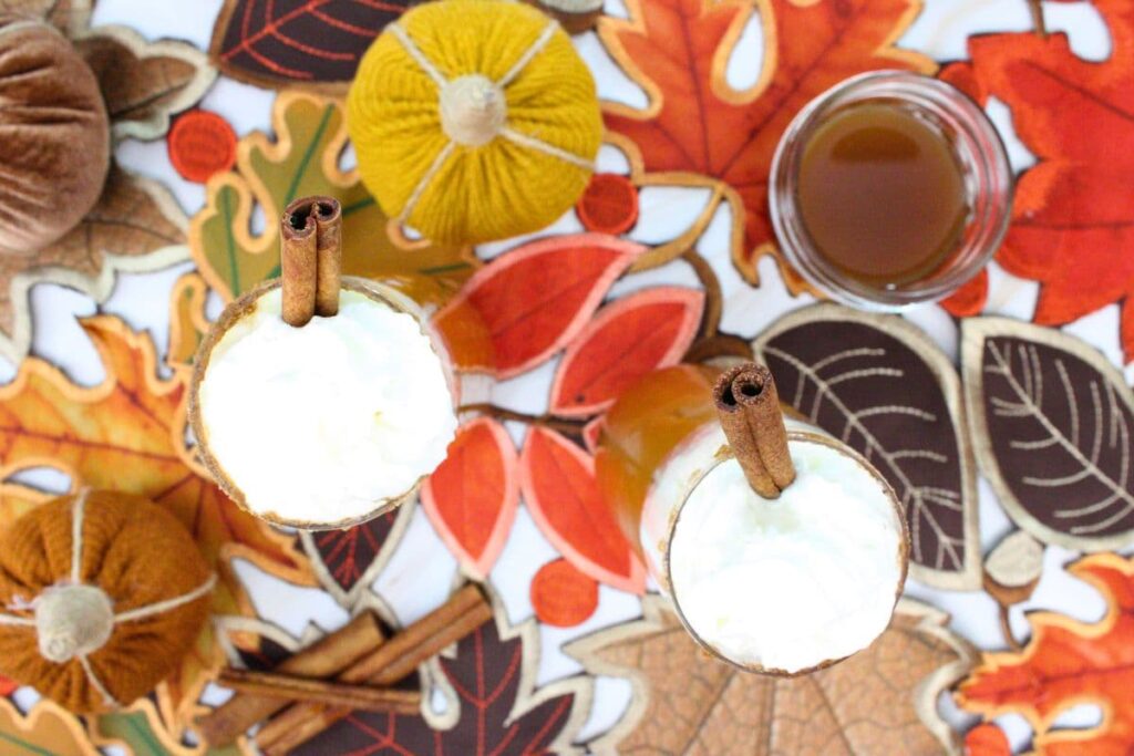 overhead view of pumpkin pie mimosa on a fall leaf pattern