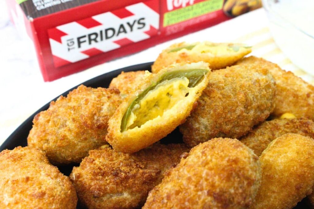 stack of tgi fridays jalapeno poppers on a plate with one cut in half