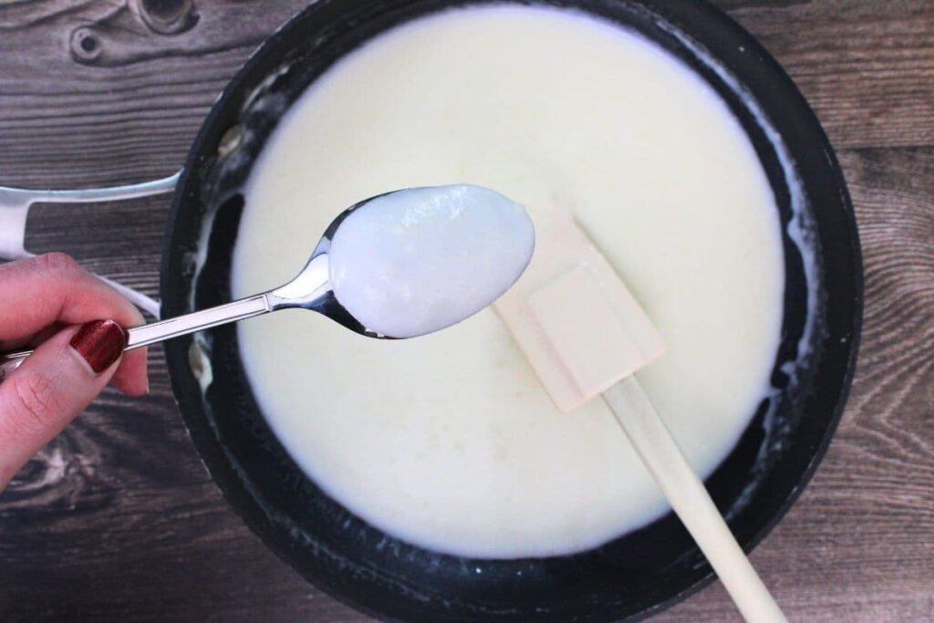 add milk and stir until it coats the back of a spoon