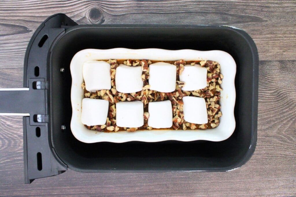 add pecans and marshmallows on top of cooked sweet potatoes