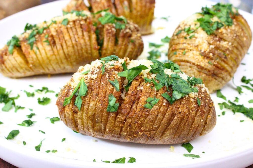 closeup of a microwave hasselback potato topped with parmesan and parsley