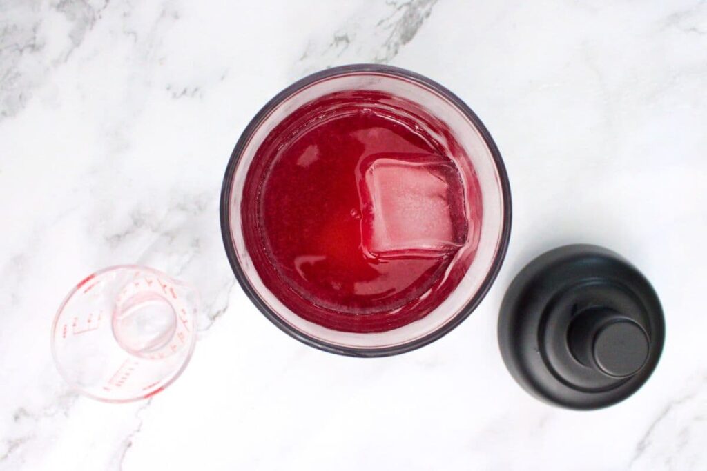 combine pomegranate martini ingredients plus ice in shaker