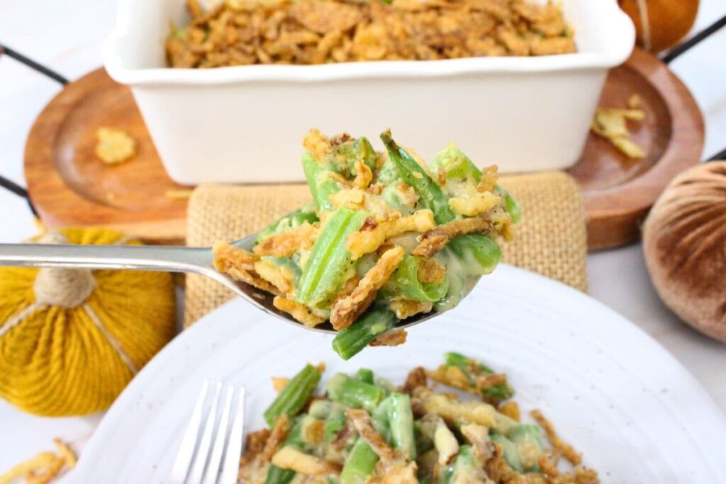 holding up a spoonful of air fryer green bean casserole