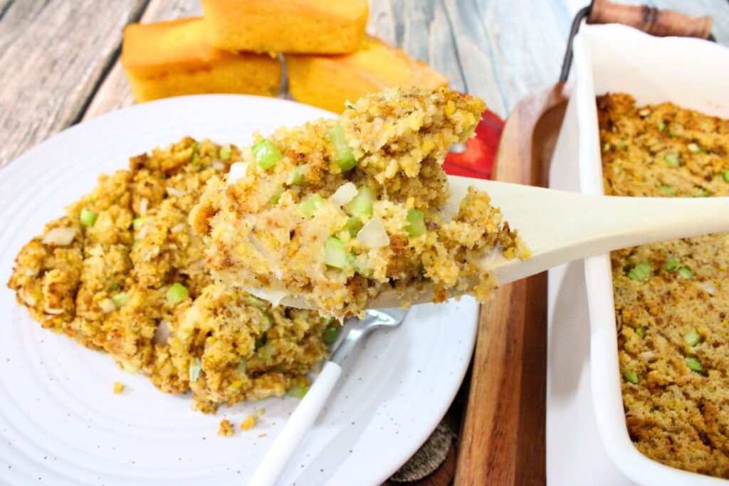 holding up air fryer cornbread dressing on a wooden spoon