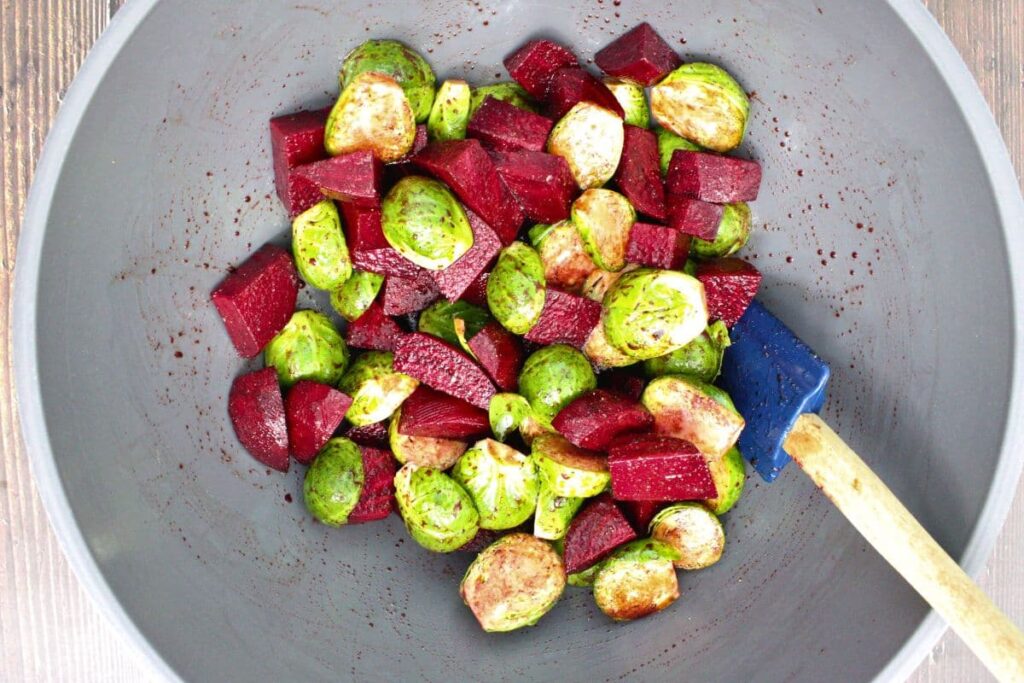 in a mixing bowl combine the brussels sprouts and beets with your seasonings