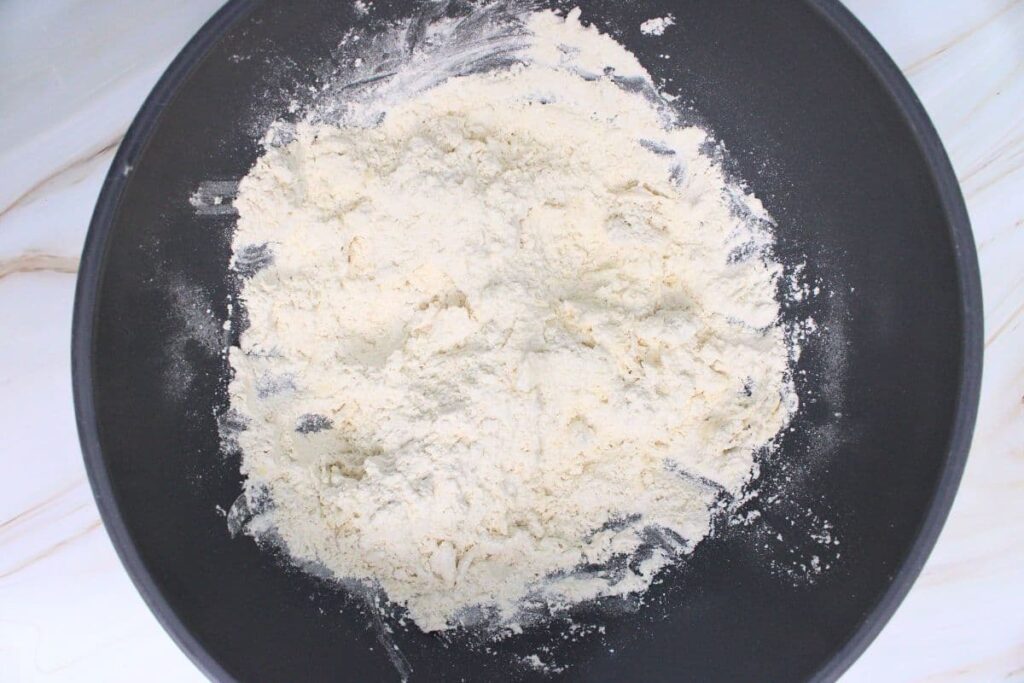 mix butter cubes into dry ingredients until it forms crumbles
