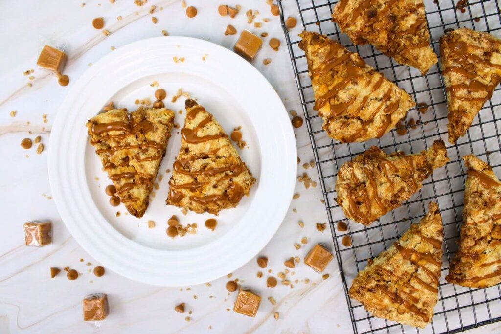 overhead view of air fryer caramel toffee scones on a plate and wire rack