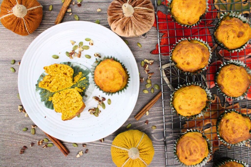 overhead view of air fryer pumpkin muffins on a plate and wire cooling rack
