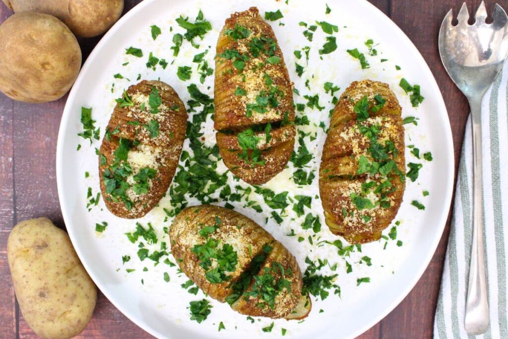 overhead view of hasselback potatoes made in the microwave with parmesan cheese and parsley