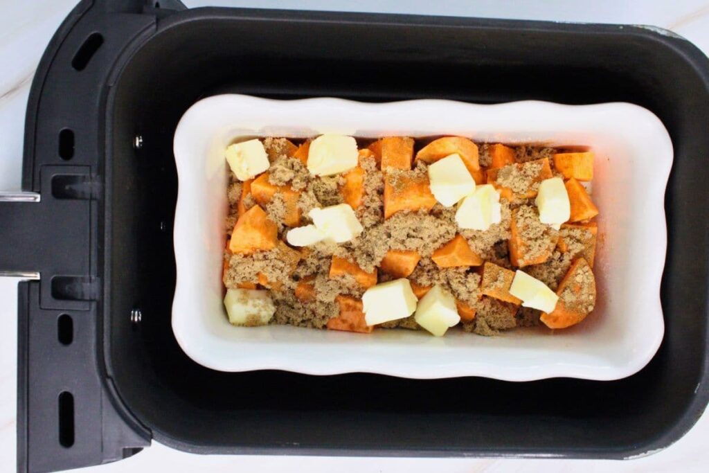 place the filled sweet potato casserole dish in the air fryer basket