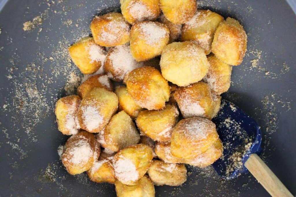 roll cooked bites in cinnamon, sugar, and melted butter mixture