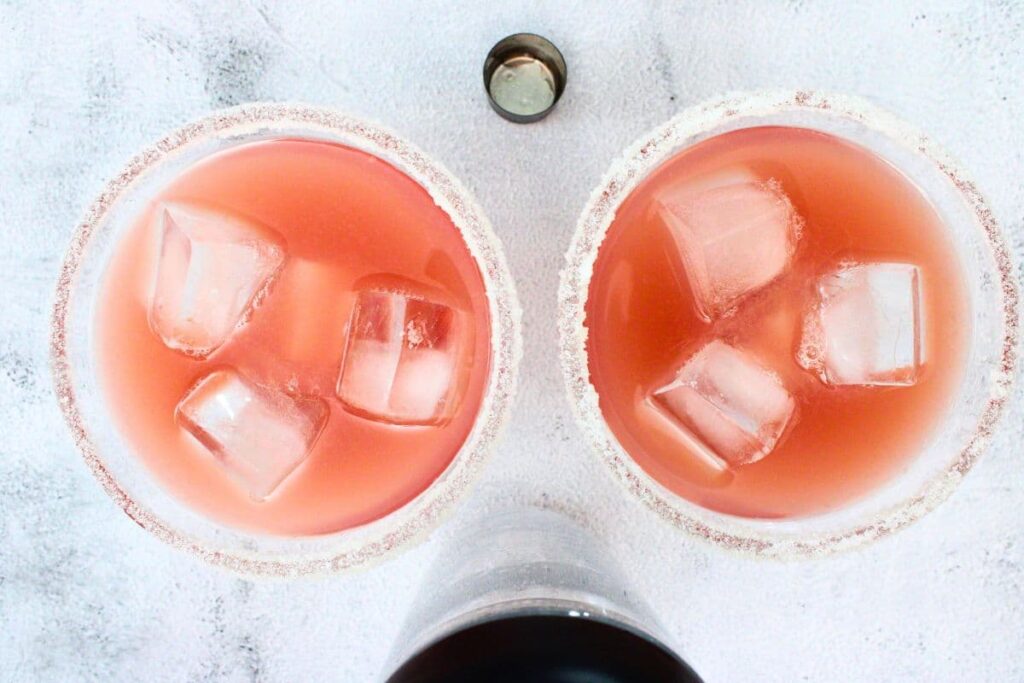 shake and strain cranberry orange margarita into a glass with ice