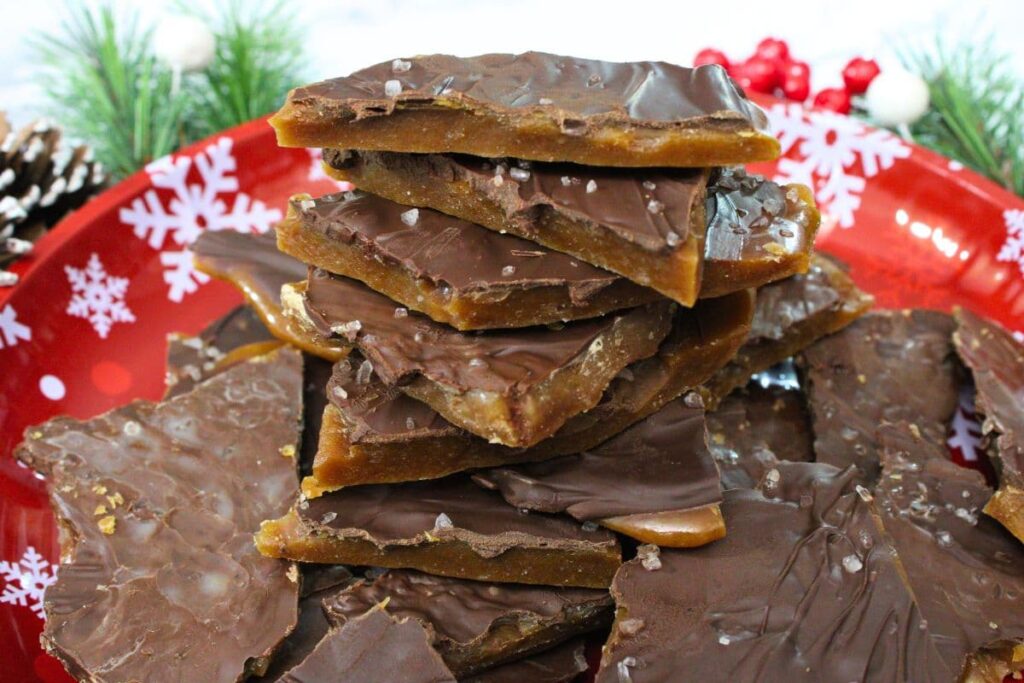 stacked up toffee made in the microwave on a red snowflake plate