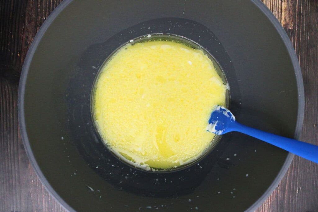 beat eggs and mix in sour cream, milk, oil, orange juice, and vanilla extract in a mixing bowl