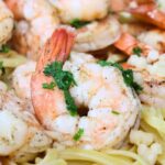 closeup view of air fryer shrimp scampi on a plate with pasta noodles