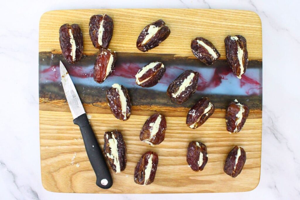 cut dates lengthwise and stuff with goat cheese