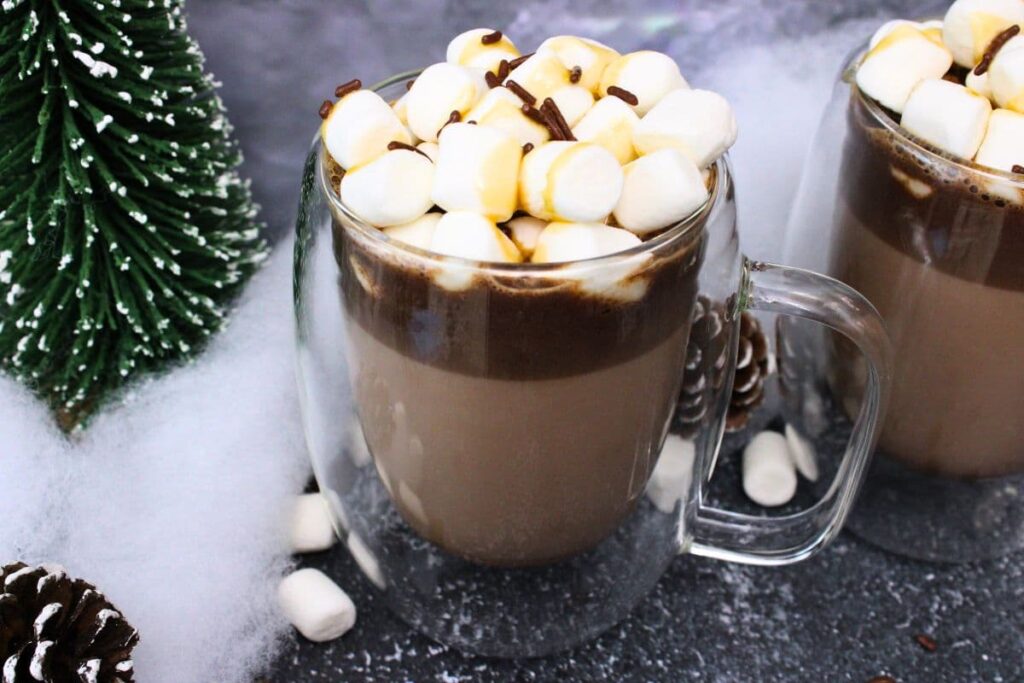 double walled glass mug filled with salted caramel whiskey hot chocolate and mini marshmallows