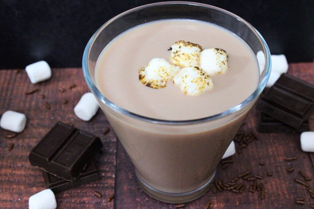 hot chocolate martini cocktail surrounded by mini marshmallows and chocolate pieces