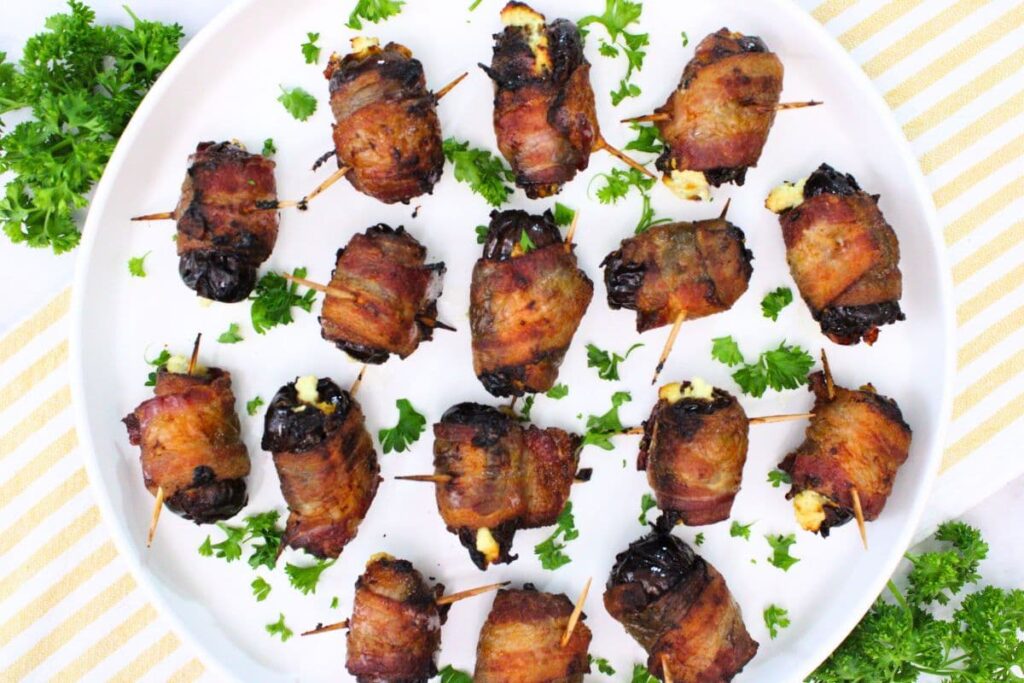 overhead view of bacon wrapped dates on a plate