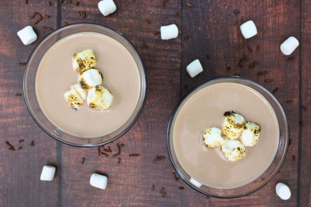 overhead view of two hot chocolate martinis surrounded by marshmallows