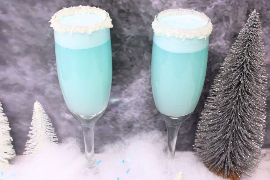 refreshing cool ice blue jack frost mimosas against a dark background