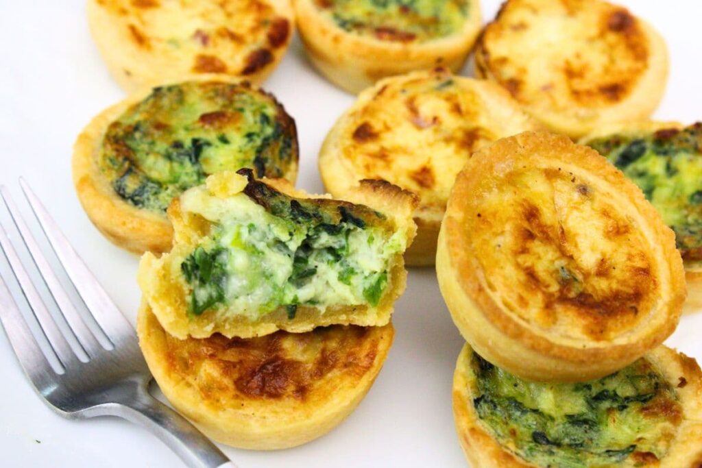 air fryer frozen mini quiche on a plate cut open and ready to eat