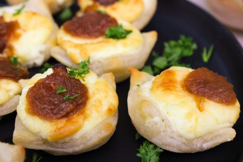 closeup view of feta cheese and caramelized onions pastry bites