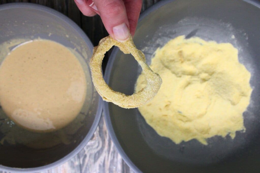 dip onion rings in the beer batter then coat in cornmeal