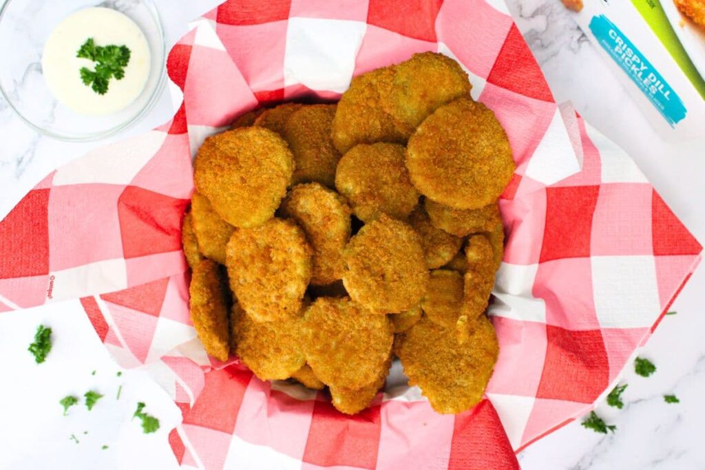overhead view of air fryer frozen fried pickles in a basket