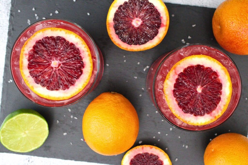 overhead view of blood orange paloma cocktails with orange slices