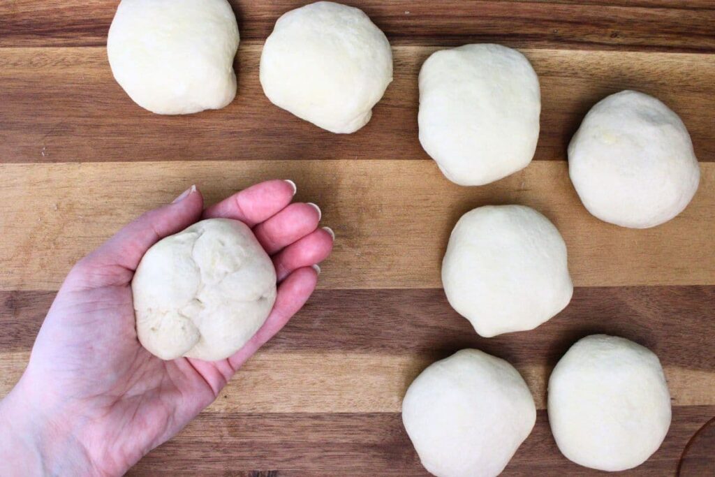 pinch and fold up the dough over the pepperoni to form a ball