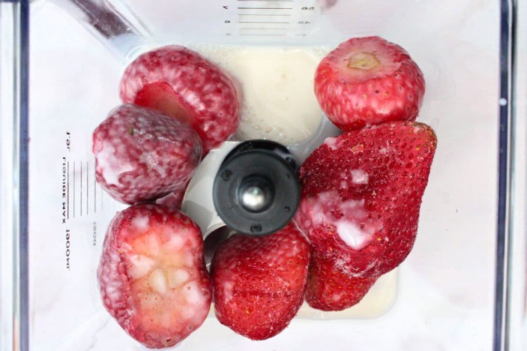 place strawberries, dates, and almond milk in blender