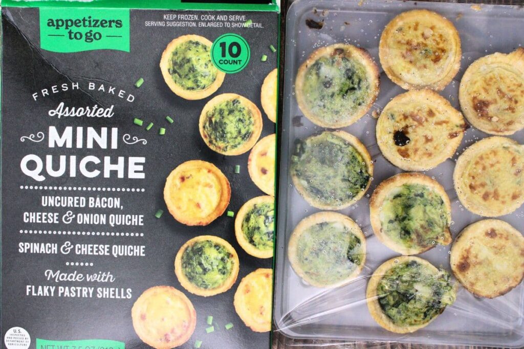 pulling frozen mini quiche in a tray out of the box