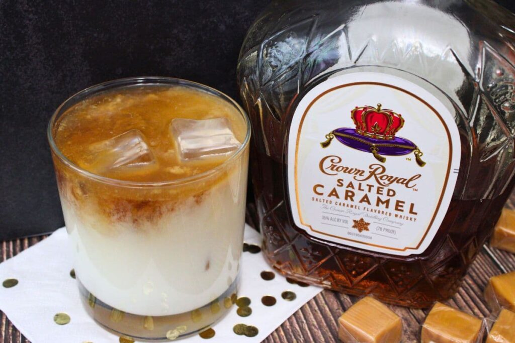 salted caramel white russian with ice cubes next to crown royal bottle