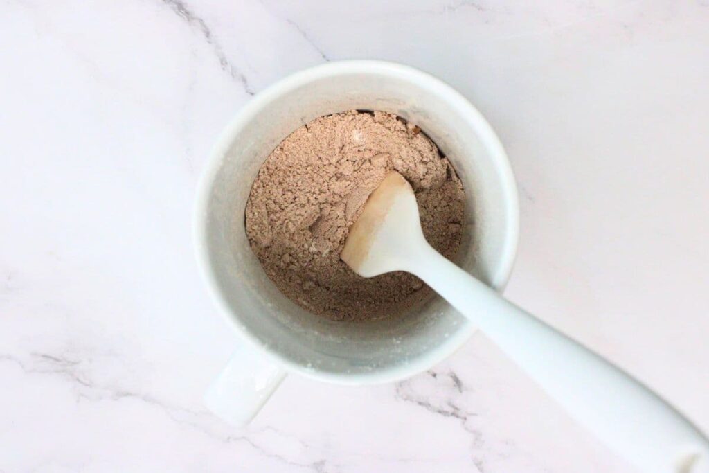 add flour, sugar, cocoa powder, baking powder, and salt to a mug
