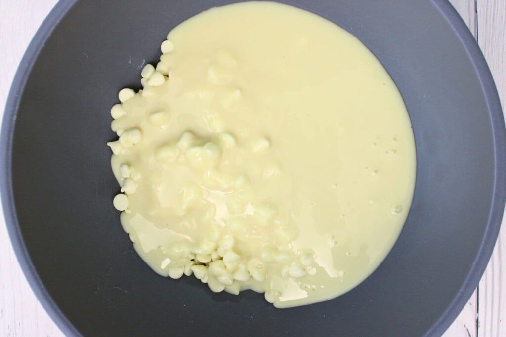 add white chocolate chips and sweetened condensed milk to a microwave safe bowl