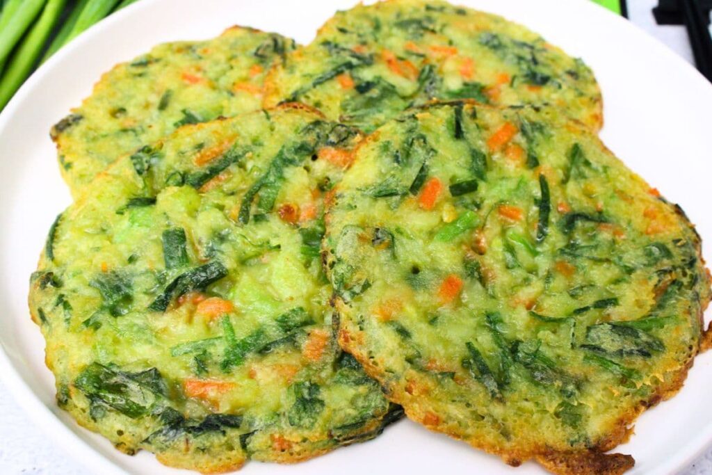 air fryer trader joes scallion pancakes laying across a white plate
