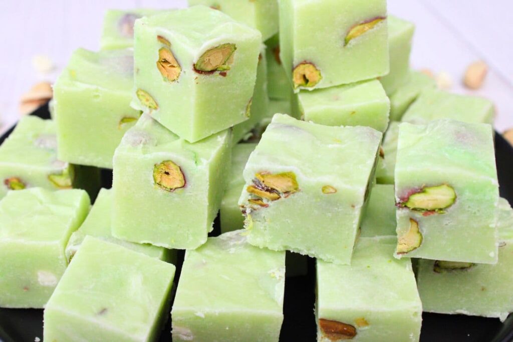 close up view of pistachio fudge stacked up on a plate
