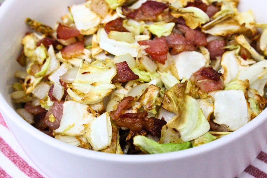 closeup view of southern air fryer cabbage and bacon in a white bowl