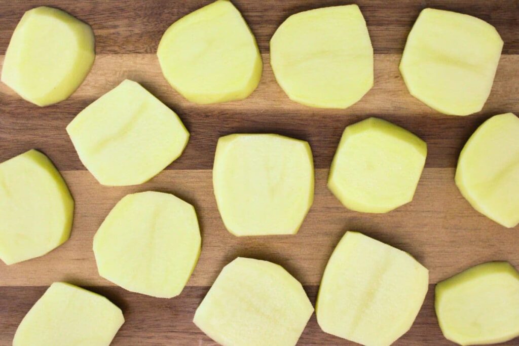 cut the potatoes lengthwise and put them in a bowl of cold water