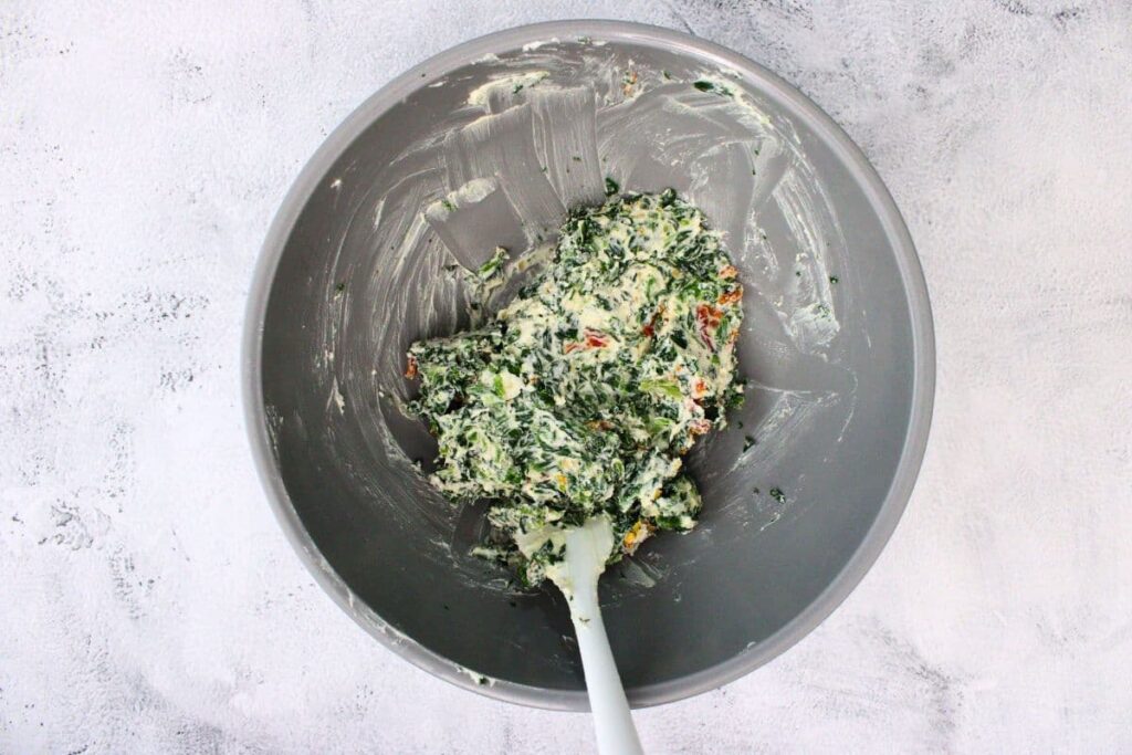 mix boursin, drained spinach, garlic, and sun dried tomatoes in a bowl