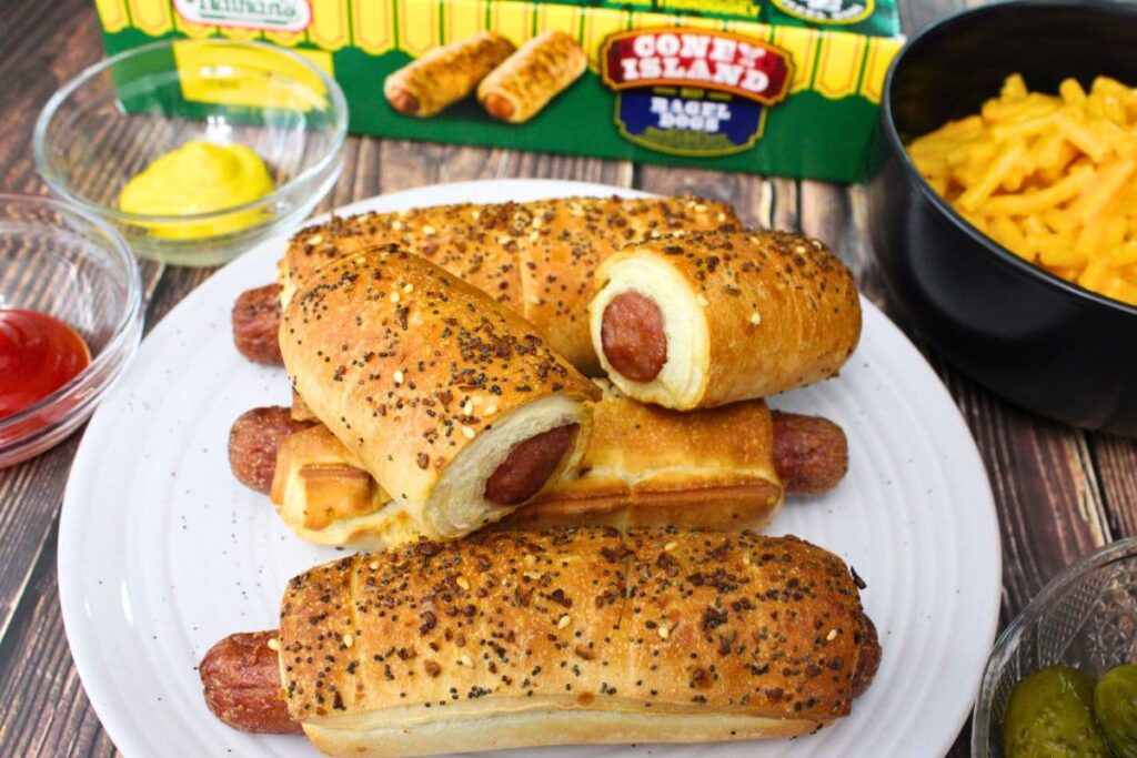 nathan's bagel dogs on a plate with one cut in half