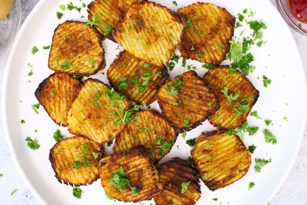 overhead view of air fryer accordion potatoes spread across a plate