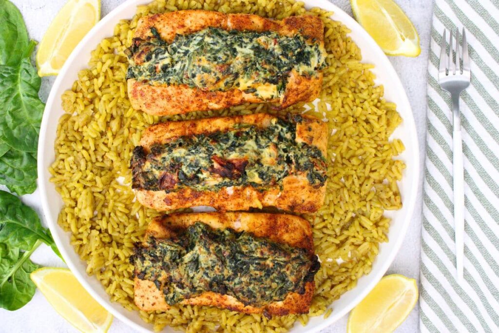 overhead view of air fryer spinach stuffed salmon on a plate of rice