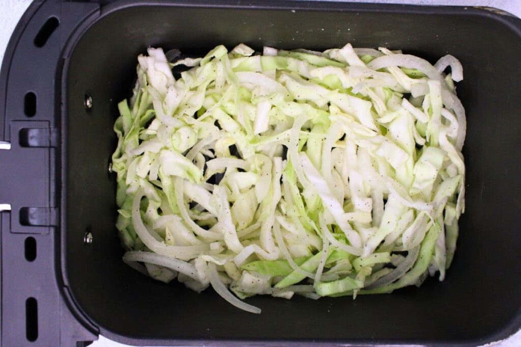 place cabbage and onions mixture in air fryer basket