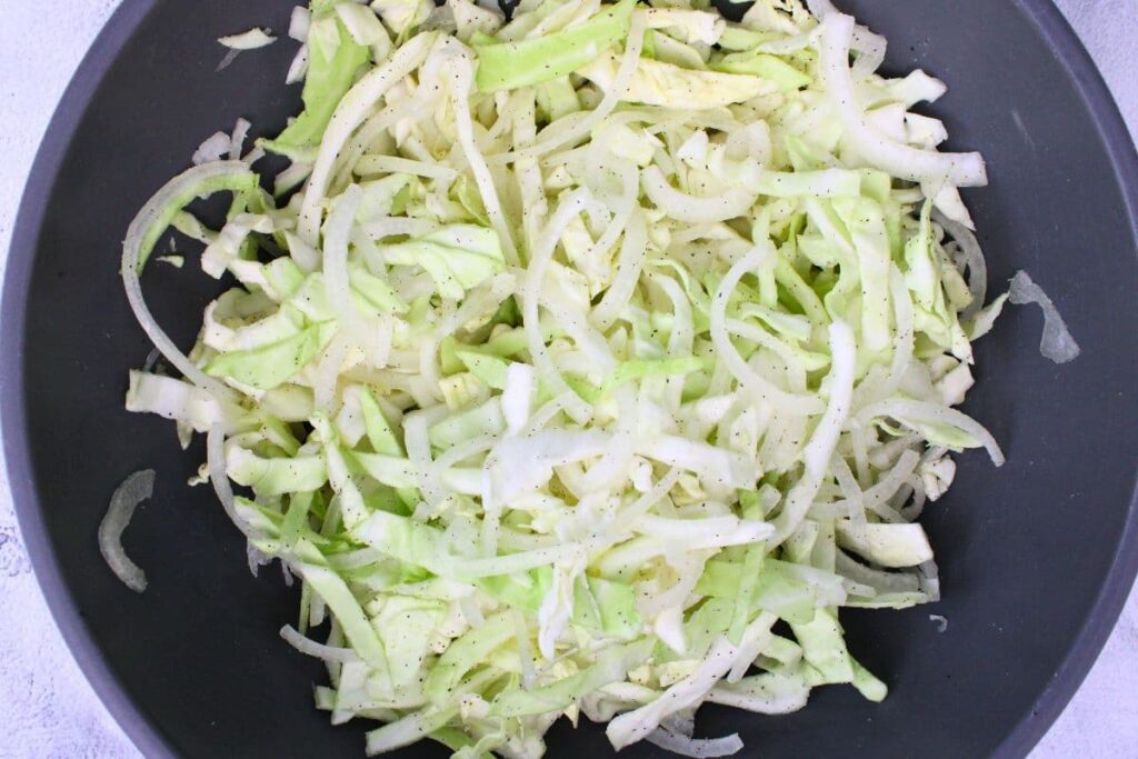 toss shredded cabbage and onion with butter salt and pepper