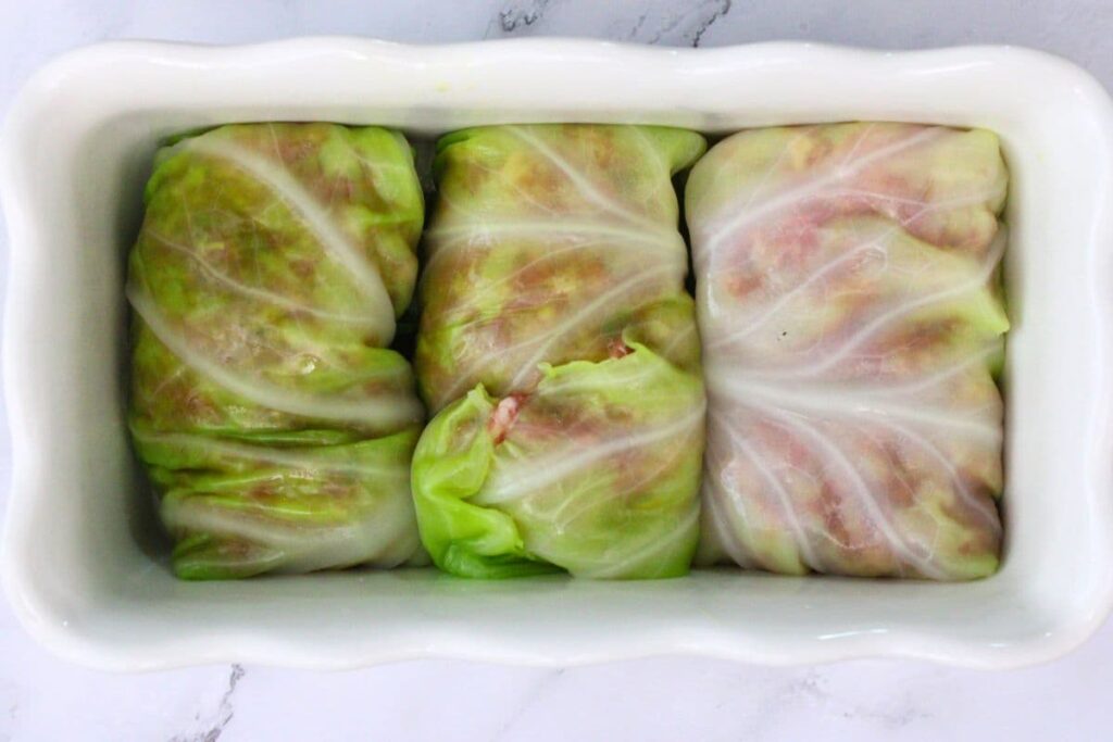 add cabbage rolls seam side down to oven safe pan